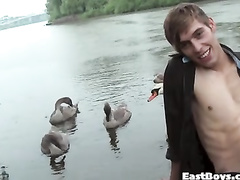 Handsome twink pleasures exciting handjob by the lake